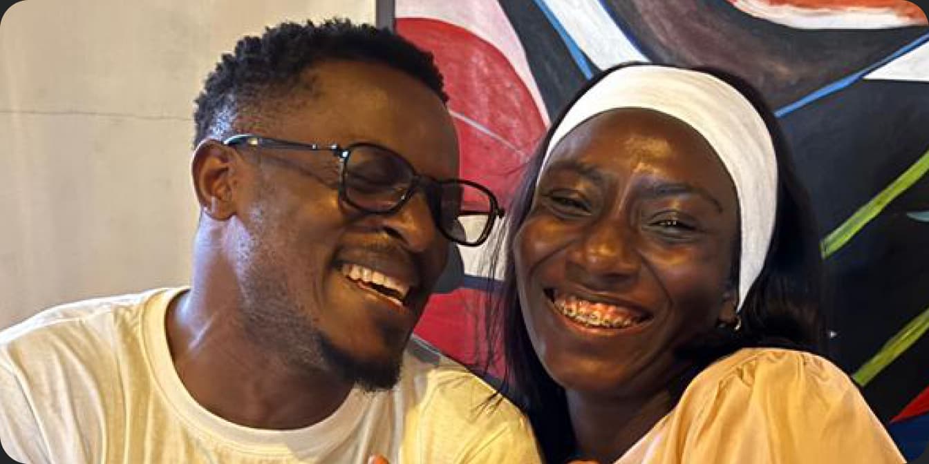 Two friends laughing together at an Onijekuje Chopify event